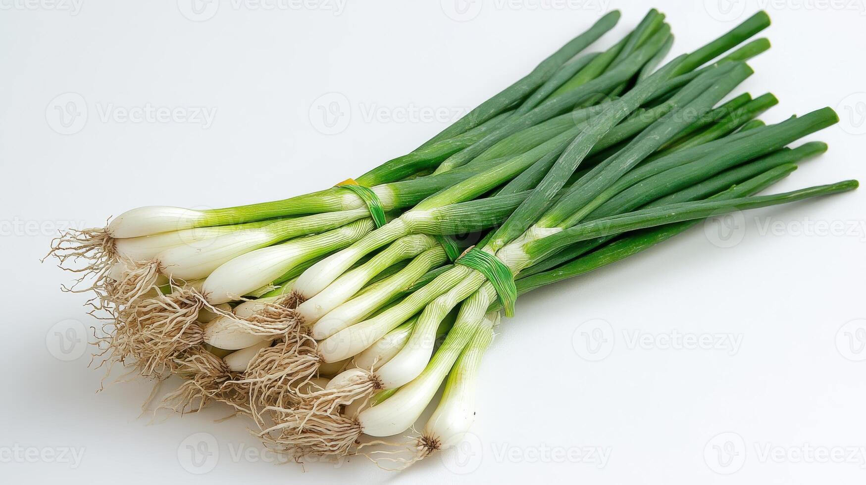 A bunch of green onions on a white surface photo