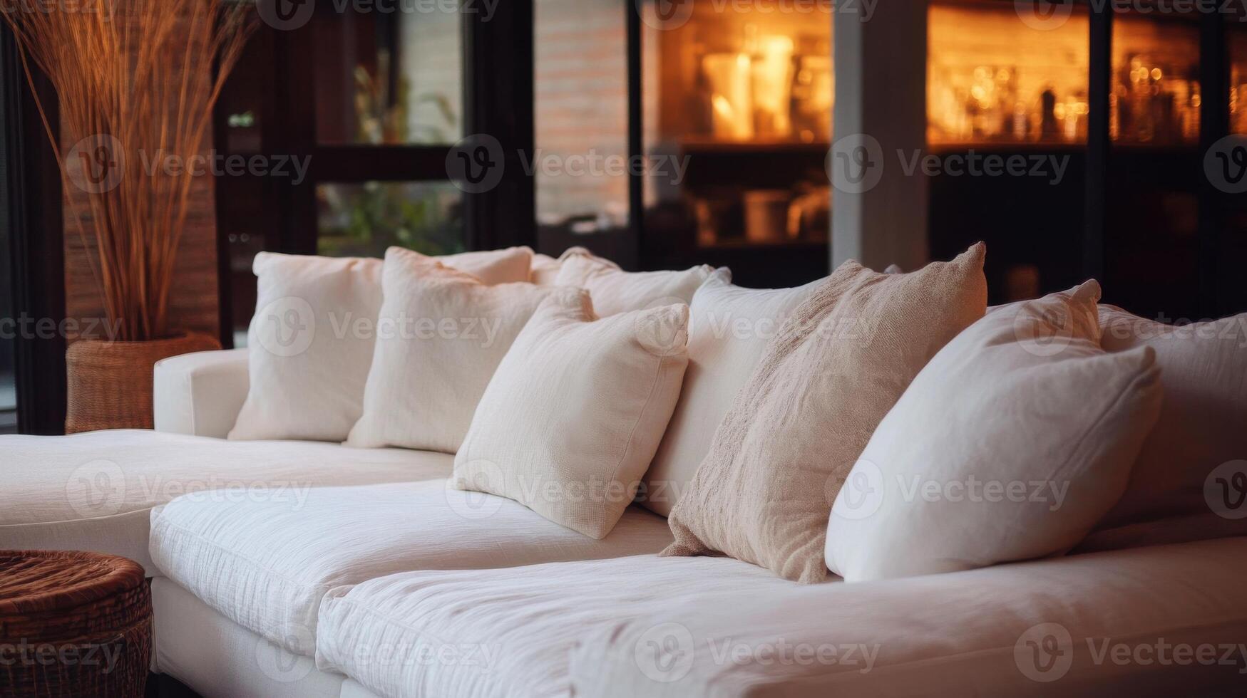 A white couch with pillows and a coffee table photo
