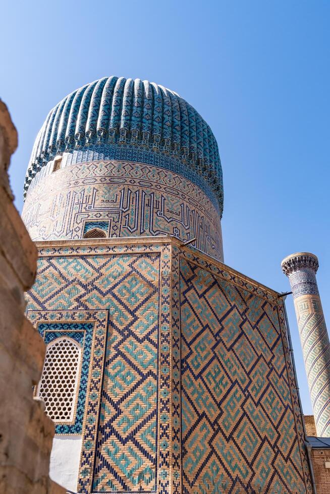 Tashkent, Uzbekistan-august 12, 2023-view of the Tamerlane Mausoleum with decorated tombs, mosaics and carvings during a sunny day photo