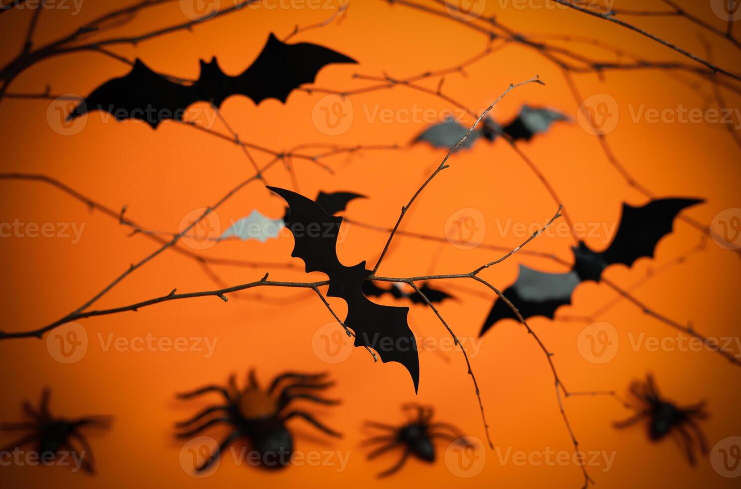 Halloween background with spiders, bats on orange background. Close-up. Selective focus. photo