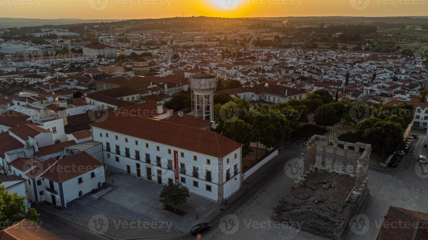 Evora, Portugal. June 4, 2024. Roman Temple in Evora at sunset, with the charming cityscape of Evora in the background, capturing the blend of ancient history and modern beauty. photo