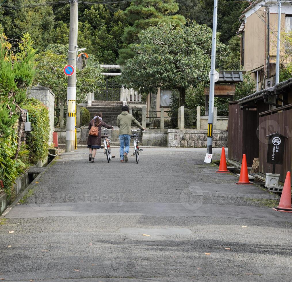 Rear view of tourists with bikes in Japan photo