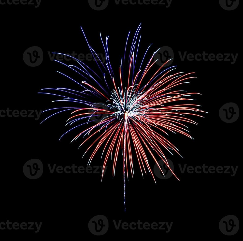 Beautiful blue and red fireworks exploding in the night sky, isolated on black background photo
