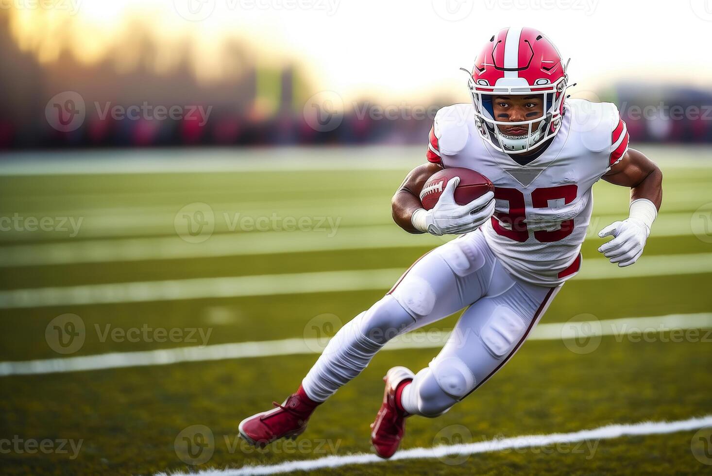 American football player in a red helmet and white uniform makes a speed maneuver with the ball in his hand during a match photo
