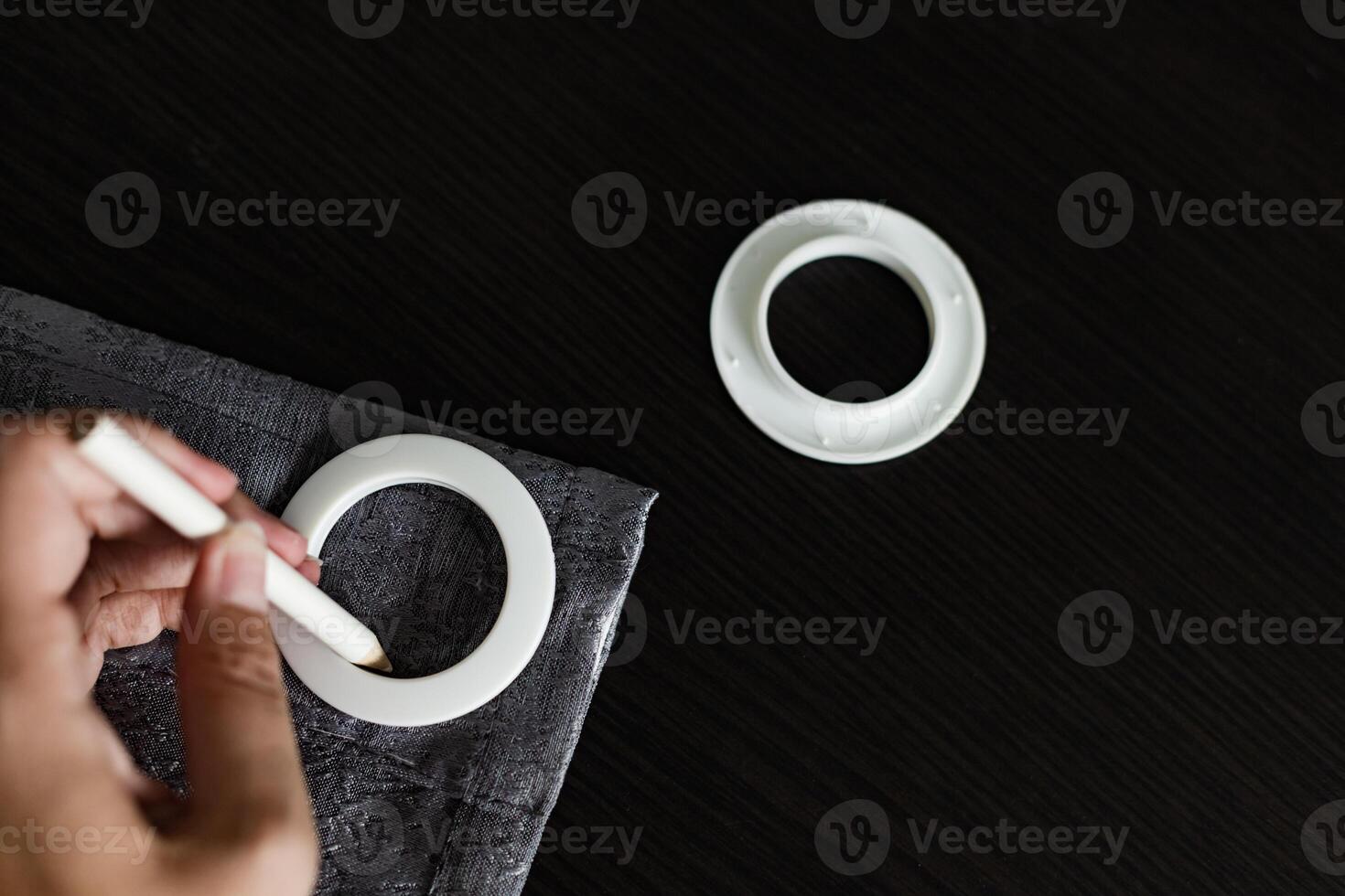 installing eyelets in curtain, marking for grommet installation photo