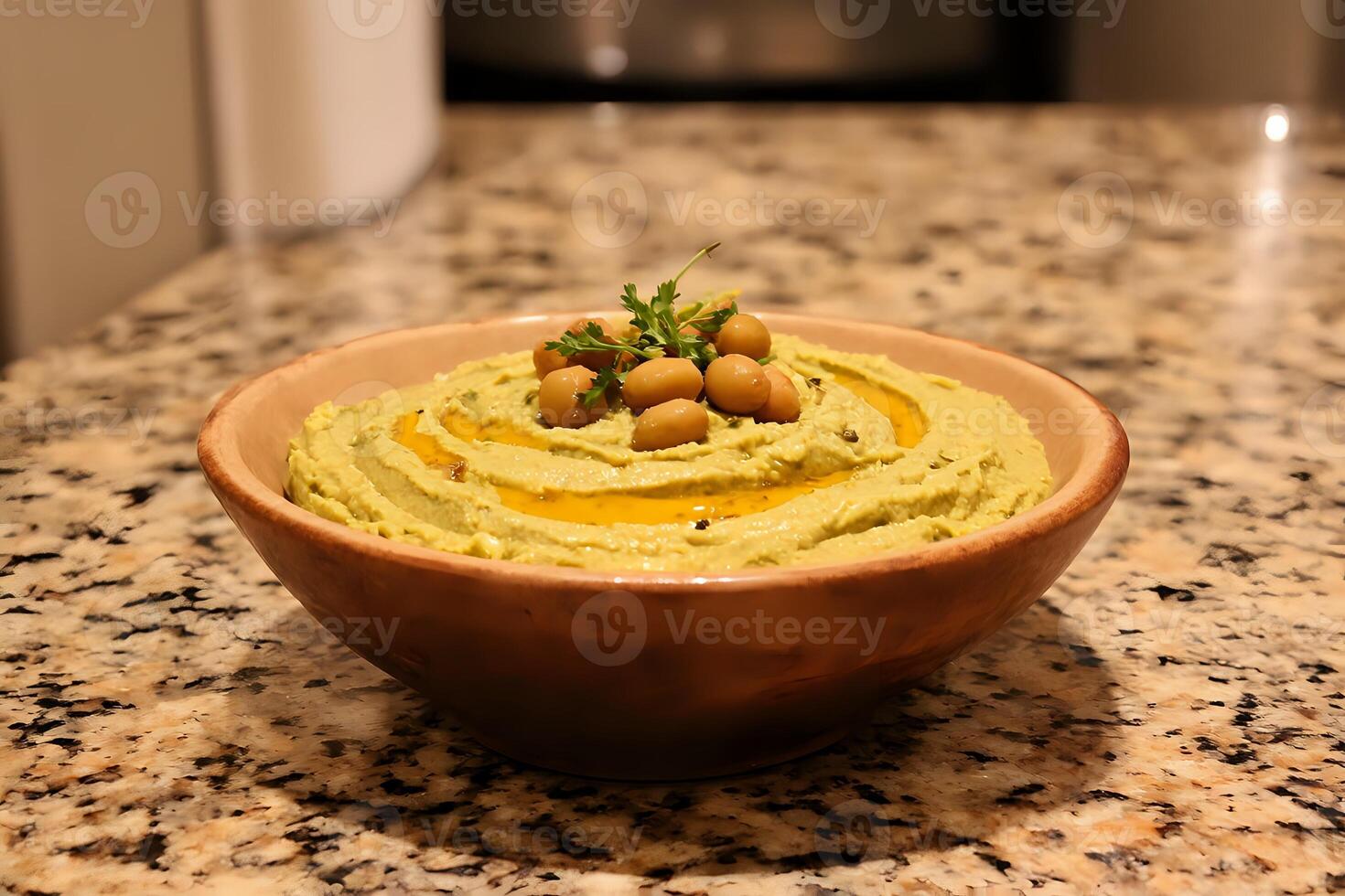 Creamy hummus with olive oil, paprika, and chickpeas in a rustic bowl on a warm kitchen countertop photo