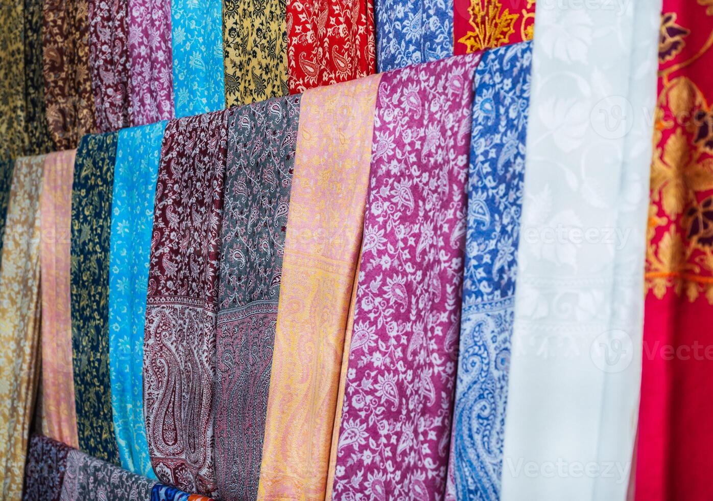 silk Turkish scarves with a bright colorful pattern at oriental bazaar in Turkey in Istanbul close-up photo