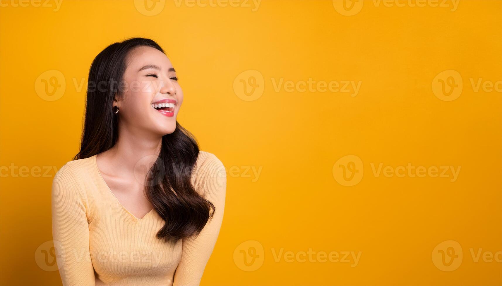 Portrait of a charming young woman laughing joyfully, isolated against a vibrant yellow background, happiness, positivity, lifestyle, self confidence, smiling woman photo