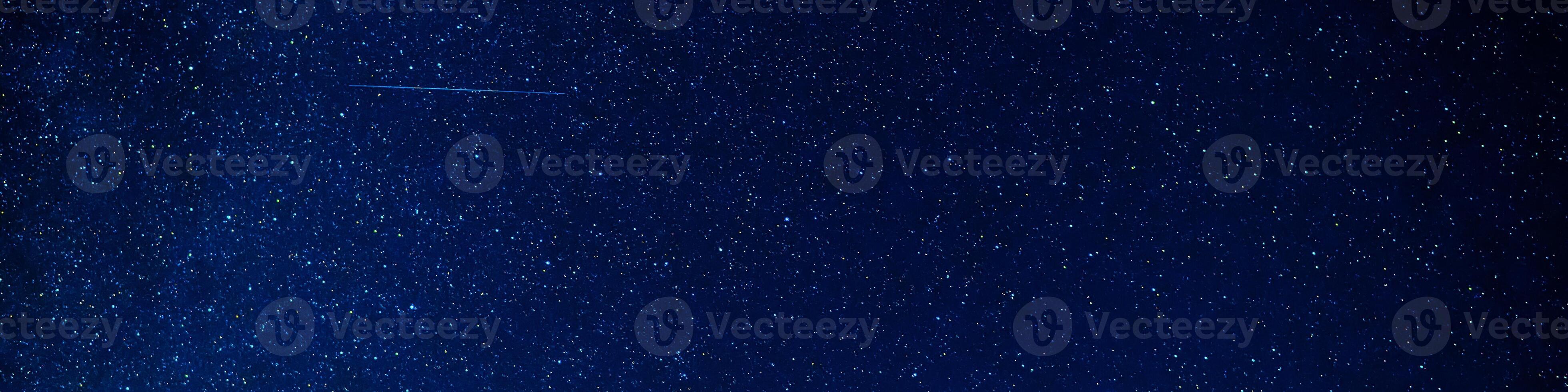 Panorama of starry sky at night on dark blue background with many stars and galaxies photo