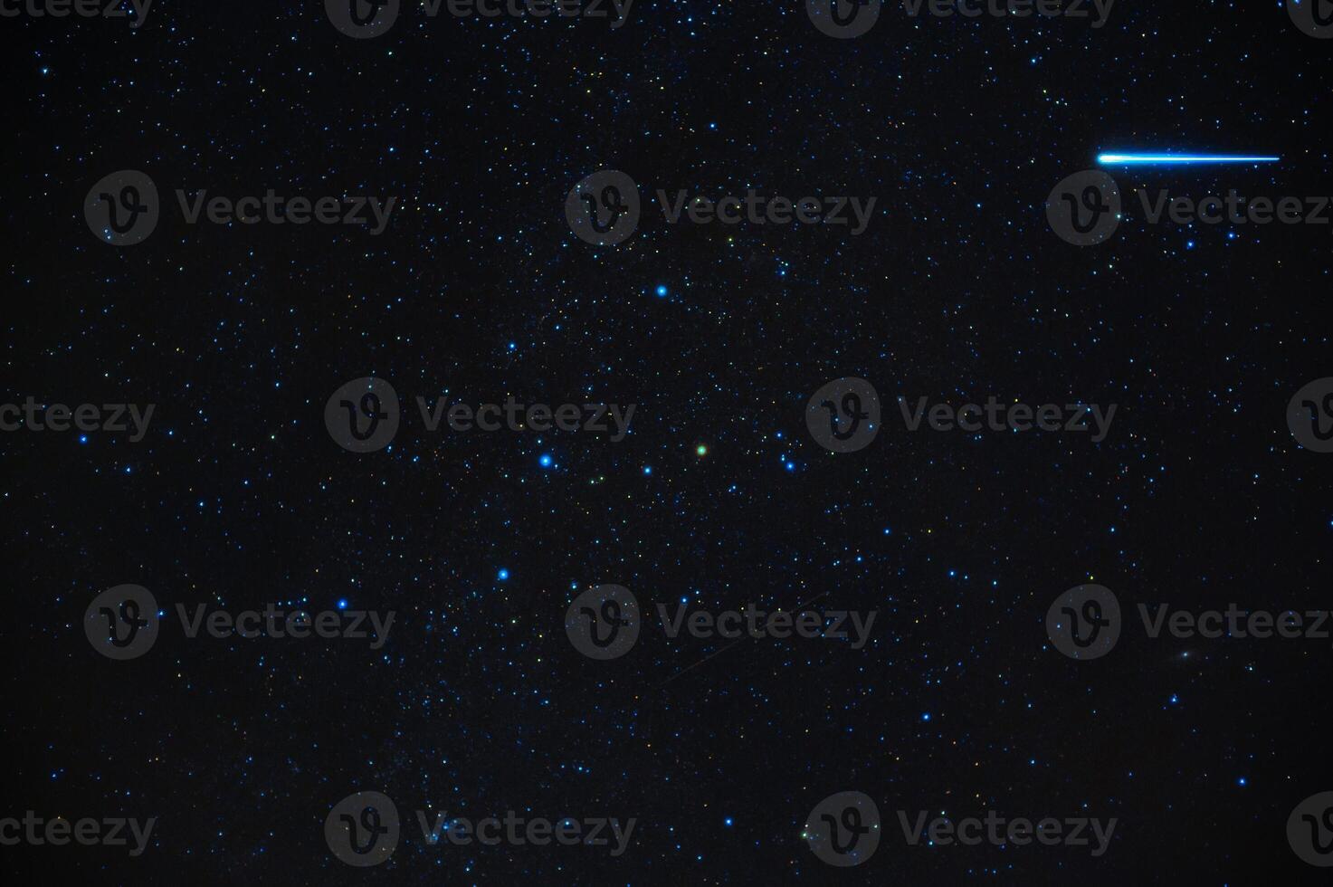 shooting star meteorite comet on background of blue dark starry sky with galaxies and nebulae photo