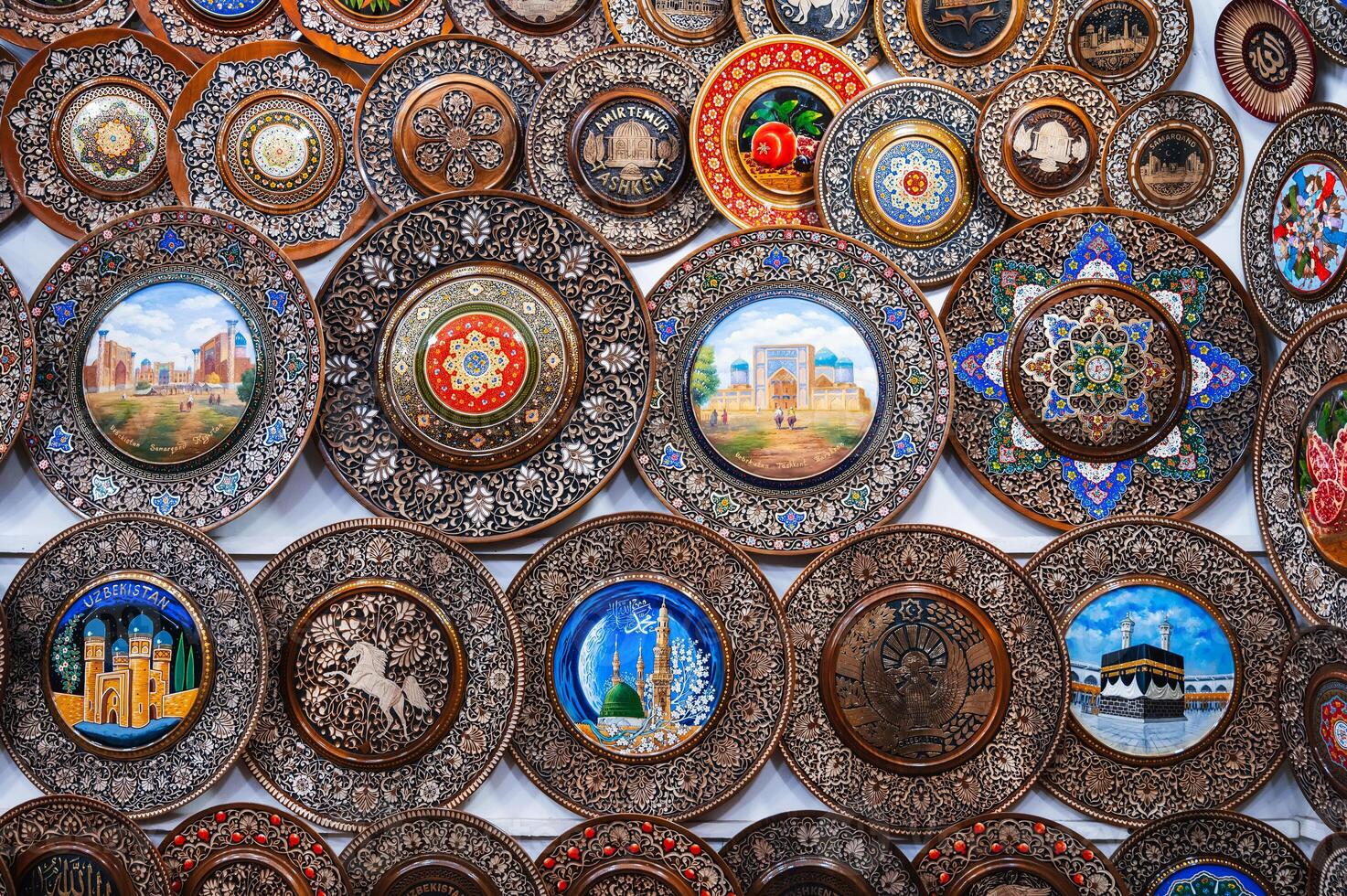 gift handmade Uzbek wooden lates with wood carvings hand-painted asian patterns in souvenir market of Uzbekistan photo