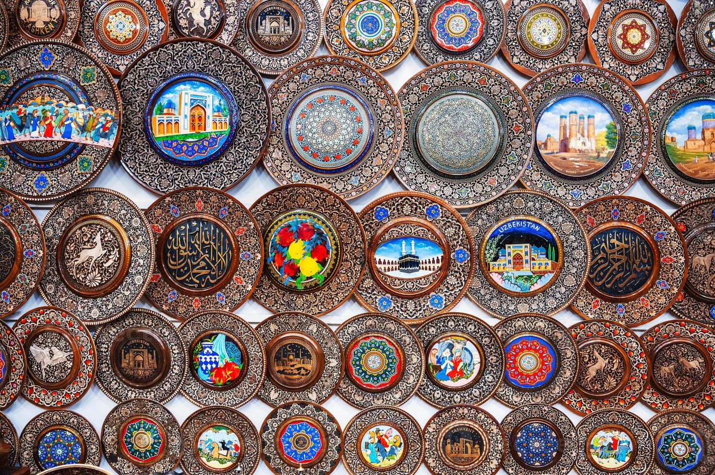 traditional Uzbek wooden handmade gift plates with wood carvings hand-painted in souvenir shop of Uzbekistan in Tashkent photo