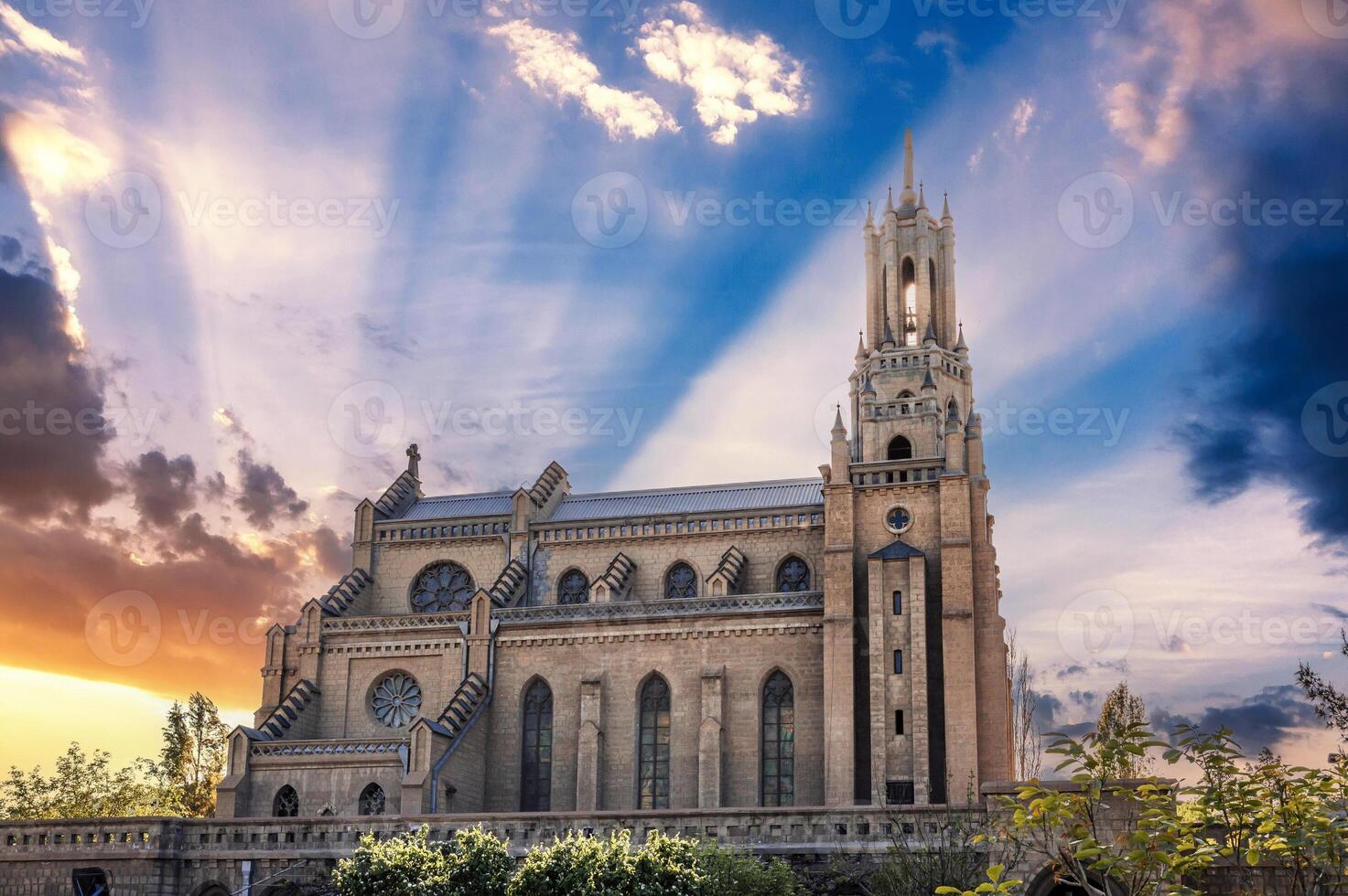 Cathedral of the Sacred Heart of Jesus in Tashkent in Uzbekistan. Exterior of ancient old gothic Church on background of beautiful sky at sunrise in spring photo