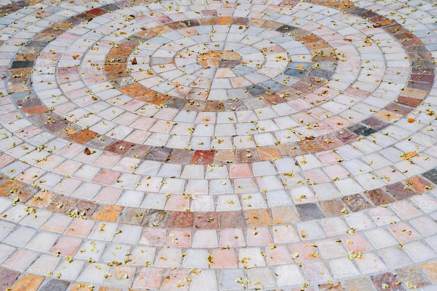 Ornate pebble pattern. The texture of the paving is made of gray cobblestones. photo