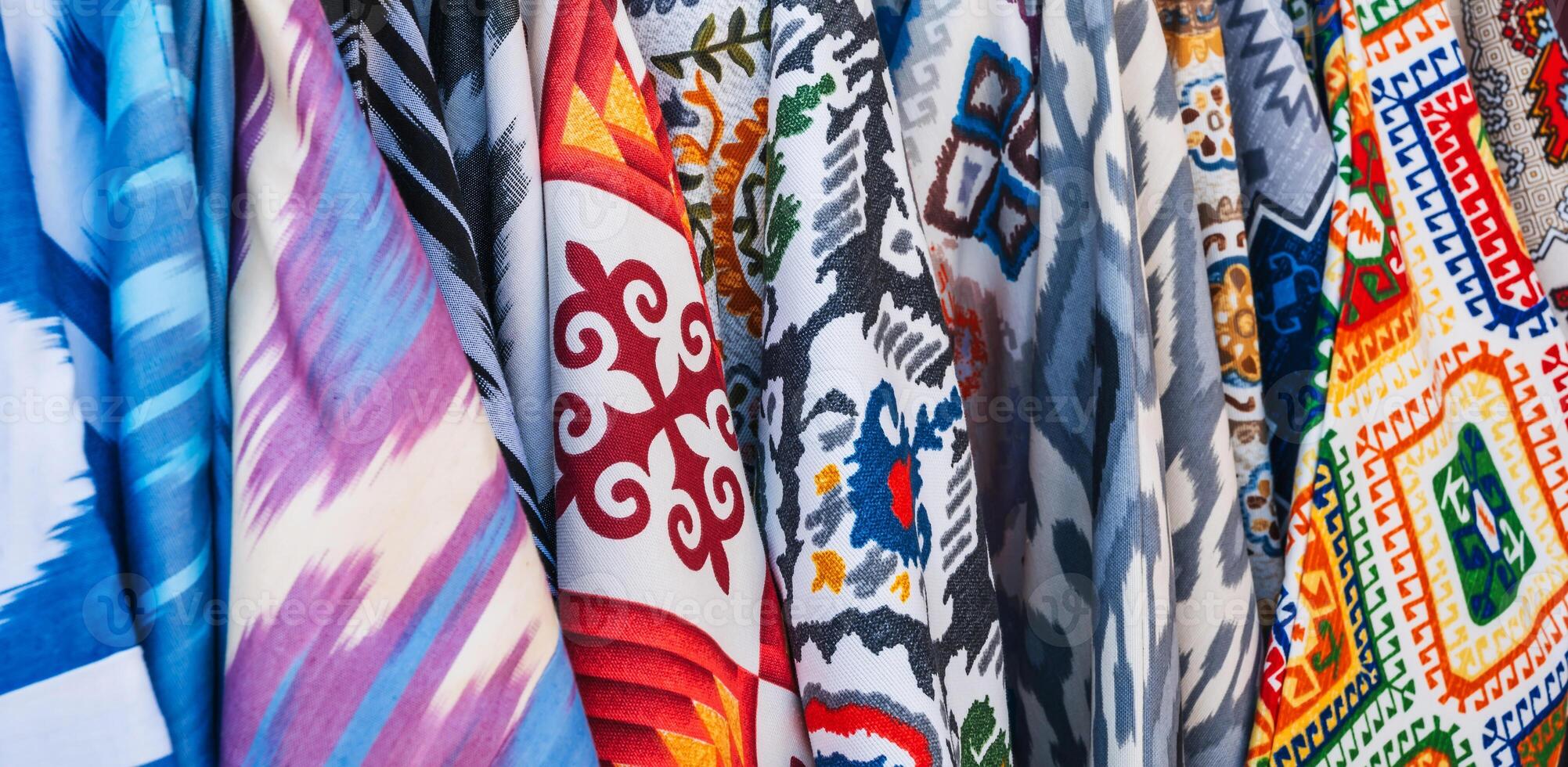 bright colorful Asian dresses at oriental bazaar close-up photo
