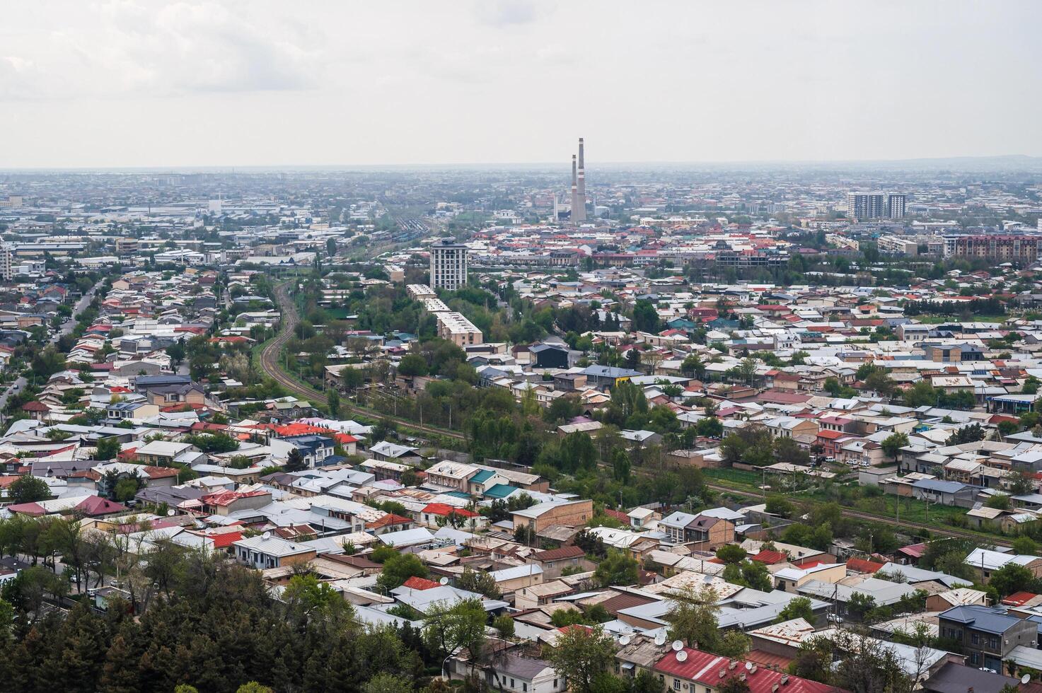 Aerial view above drone of city Tashkent from observation deck window in TV tower. Tashkent, Uzbekistan - April 16, 2024 photo