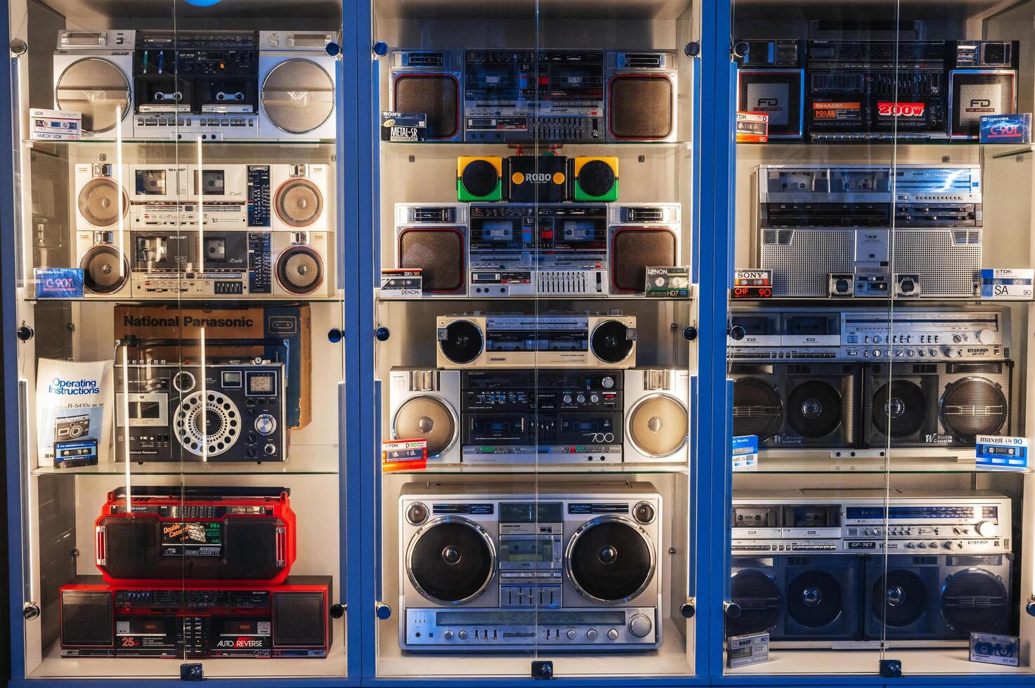 collection of different classic Japanese cassette recorders, portable boomboxes and tape audiocassettes on shop. Tashkent, Uzbekistan - April 16, 2024 photo