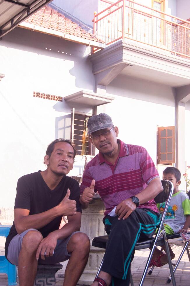 gresik, indonesia, 20 august 2023 - shot on the expression of an old indonesian man photo