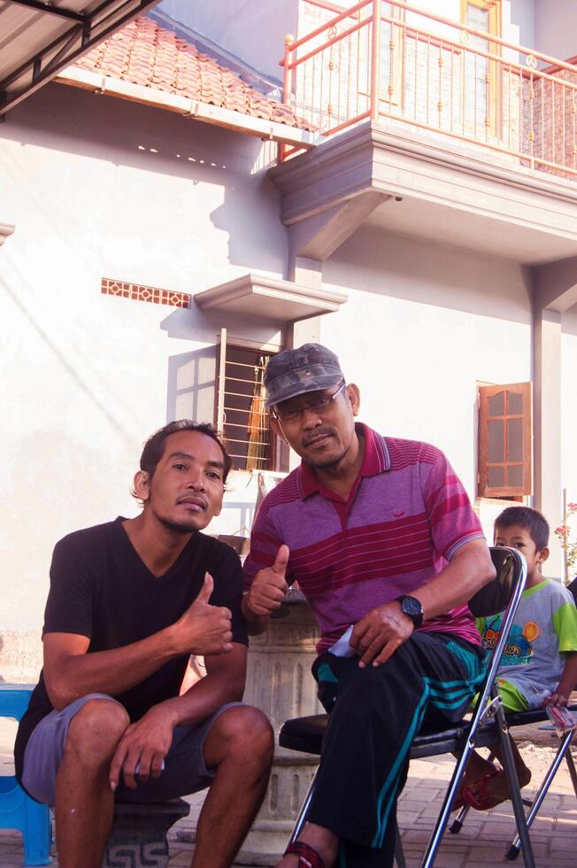gresik, indonesia, 20 august 2023 - shot on the expression of an old indonesian man photo