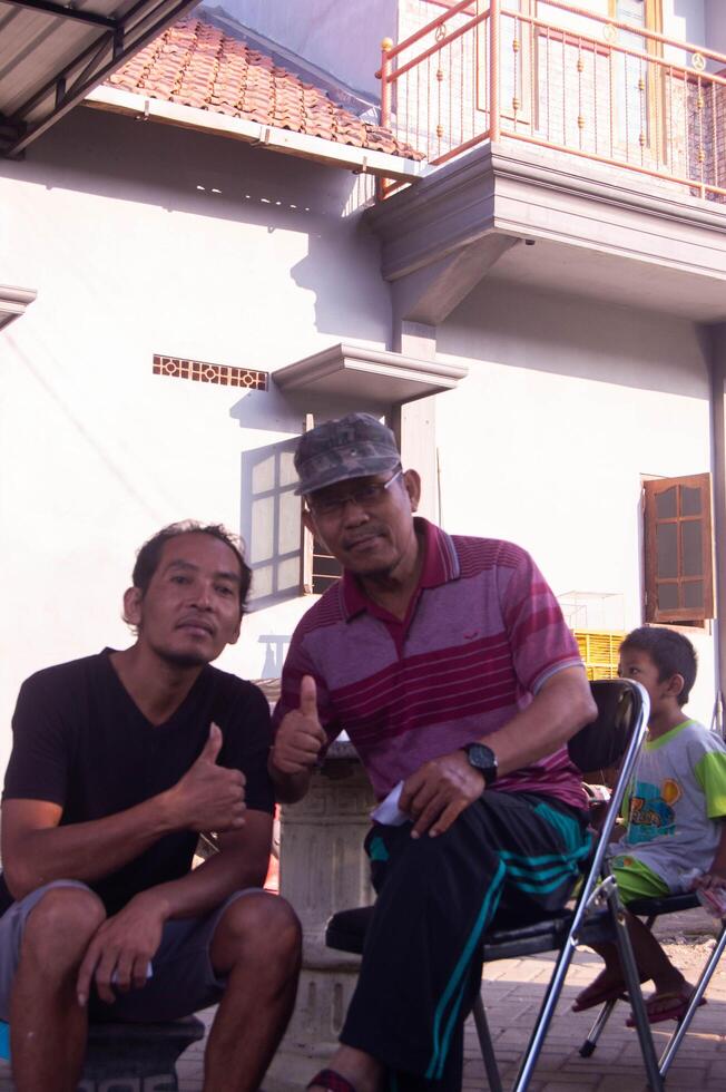 gresik, indonesia, 20 august 2023 - shot on the expression of an old indonesian man photo