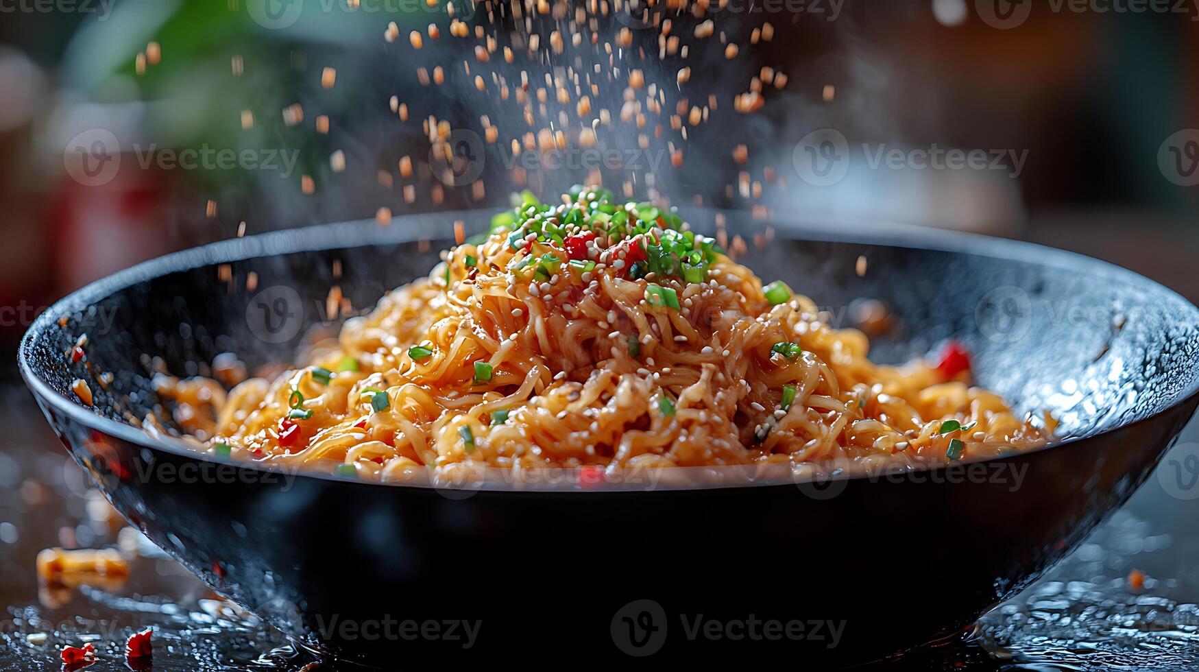 A bowl of steaming noodles with sesame seeds and green onions sprinkled on top. photo
