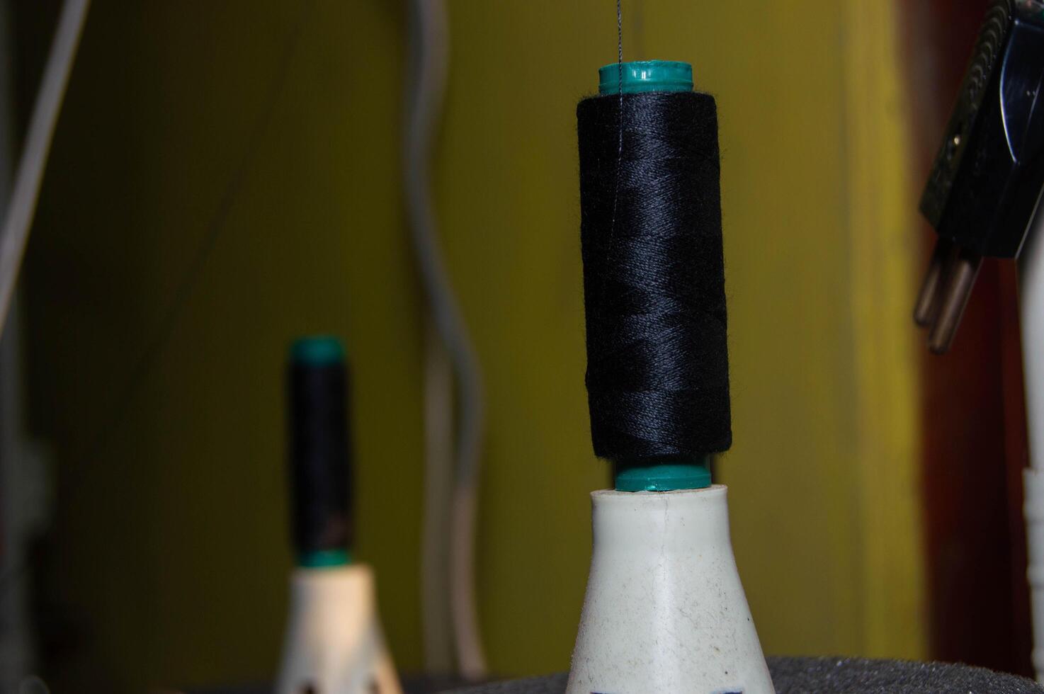 shot on black sewing thread. sewing thread installed in the machine. photo