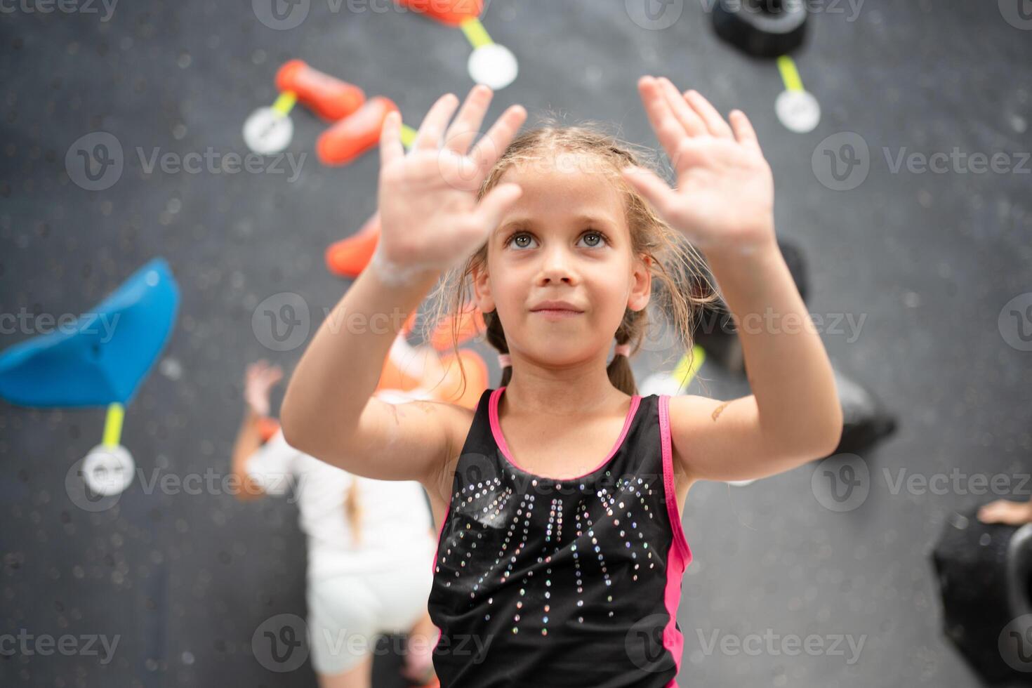 Girl climber showing hands coated with powder chalk in center photo