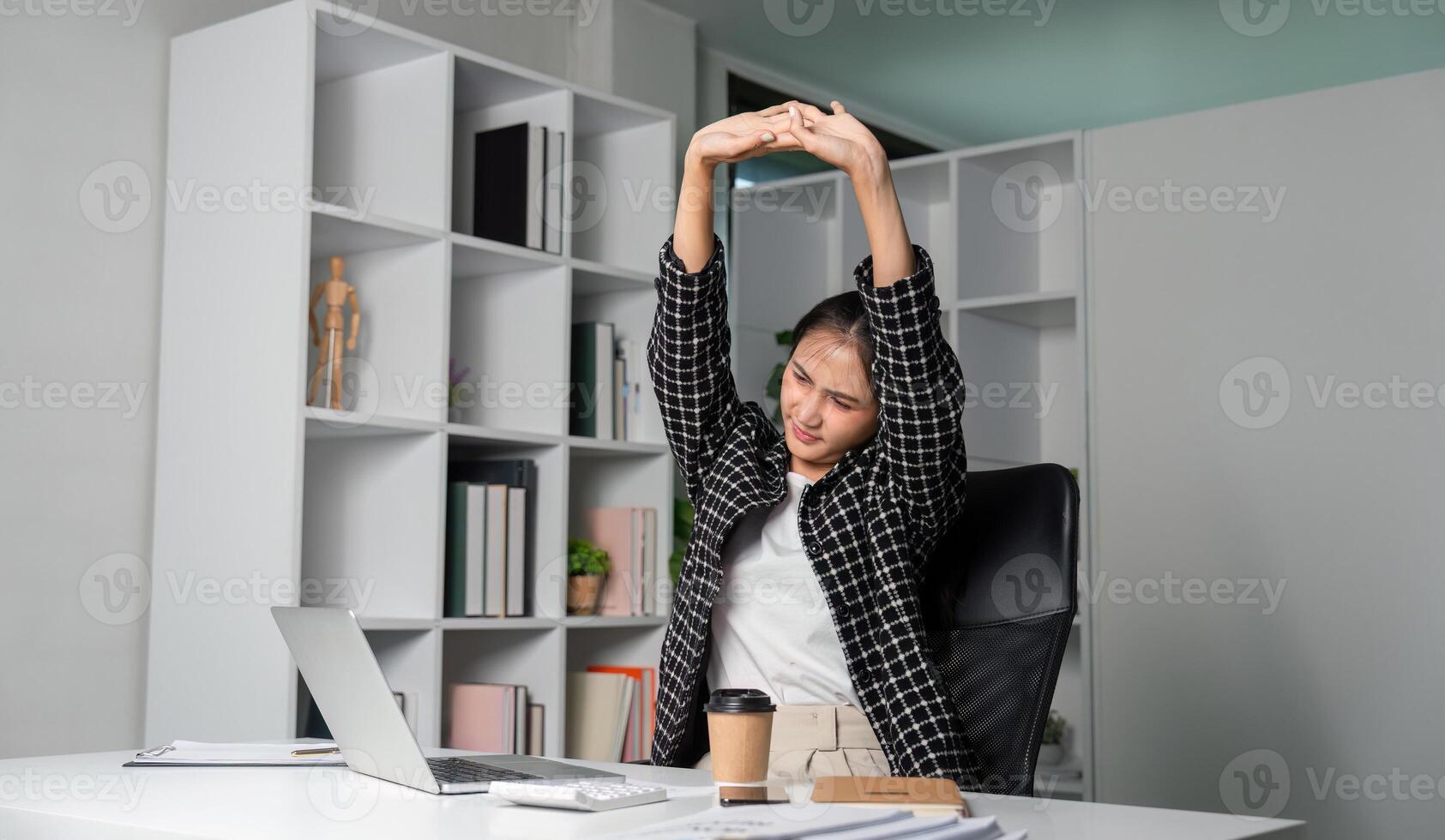 Young Business Woman Stretching and Feeling Tired from Work in Modern Office Environment photo
