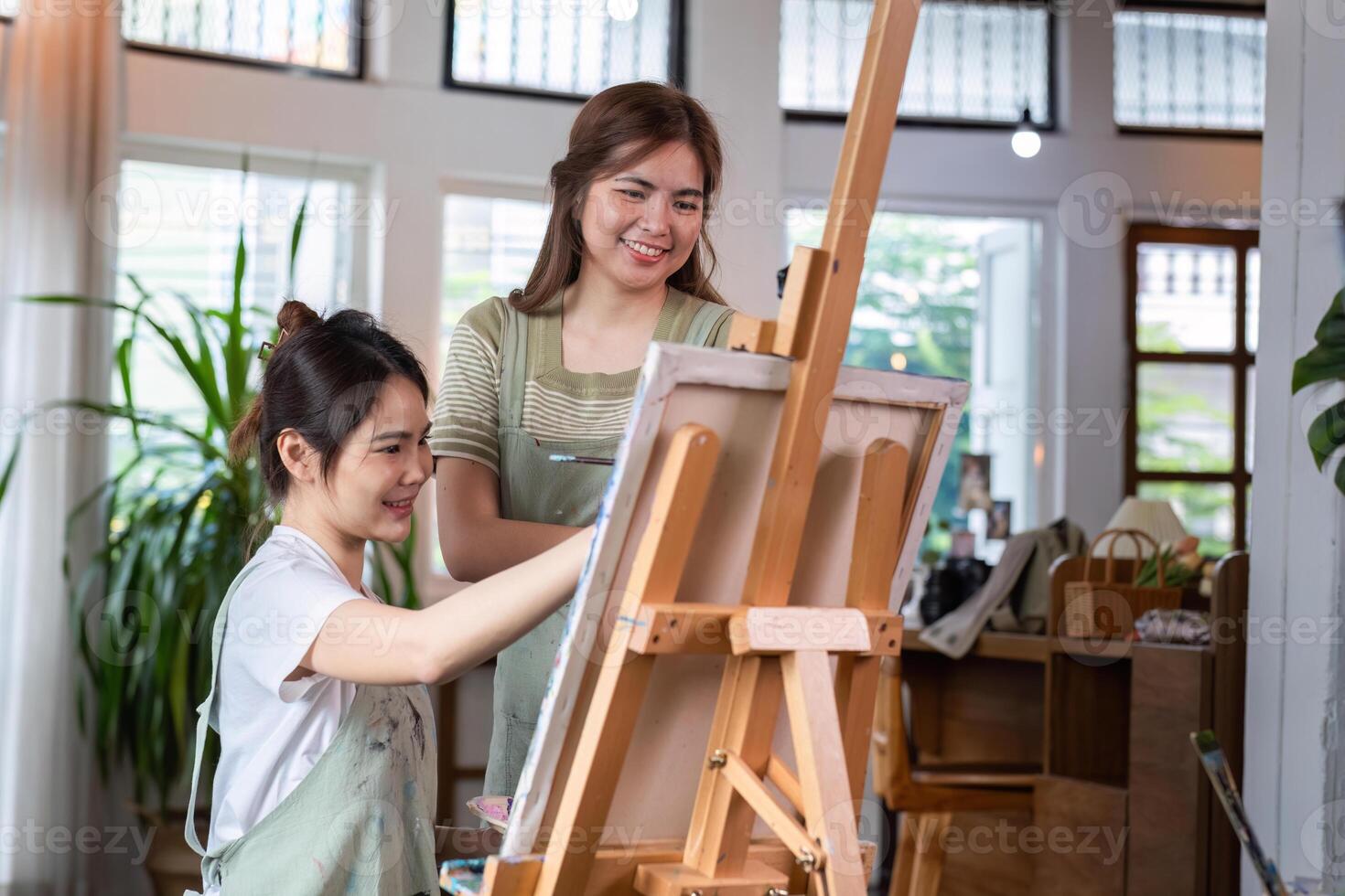 Young Women Enjoying Creative Time Together Drawing Pictures in a Bright Modern Studio photo