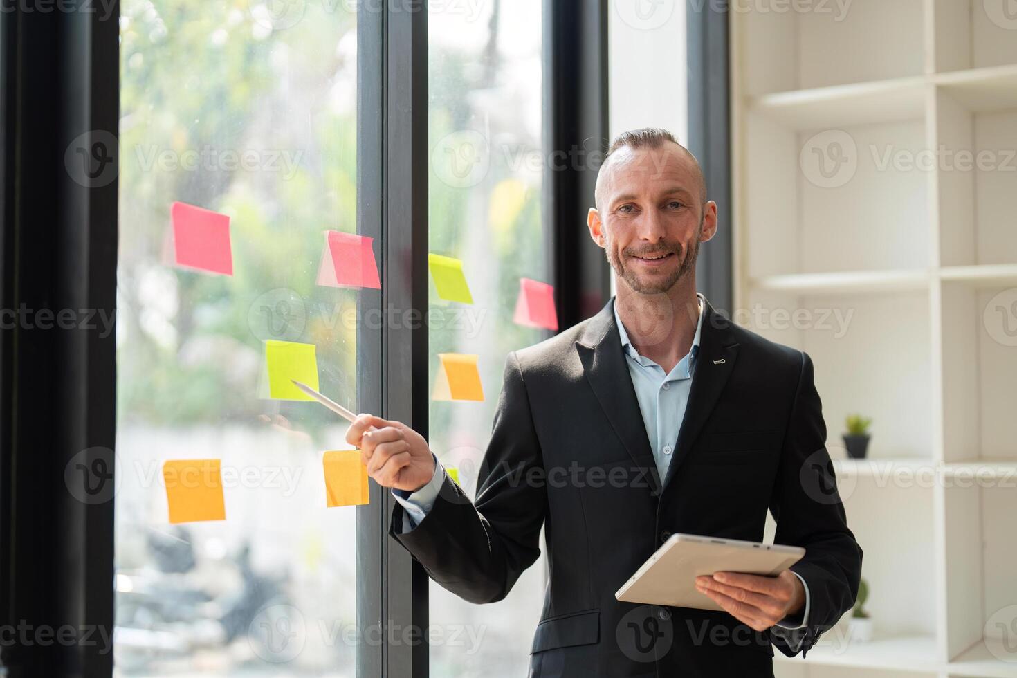 Confident Young Businessman Presenting Ideas with Determination in Modern Office Setting photo