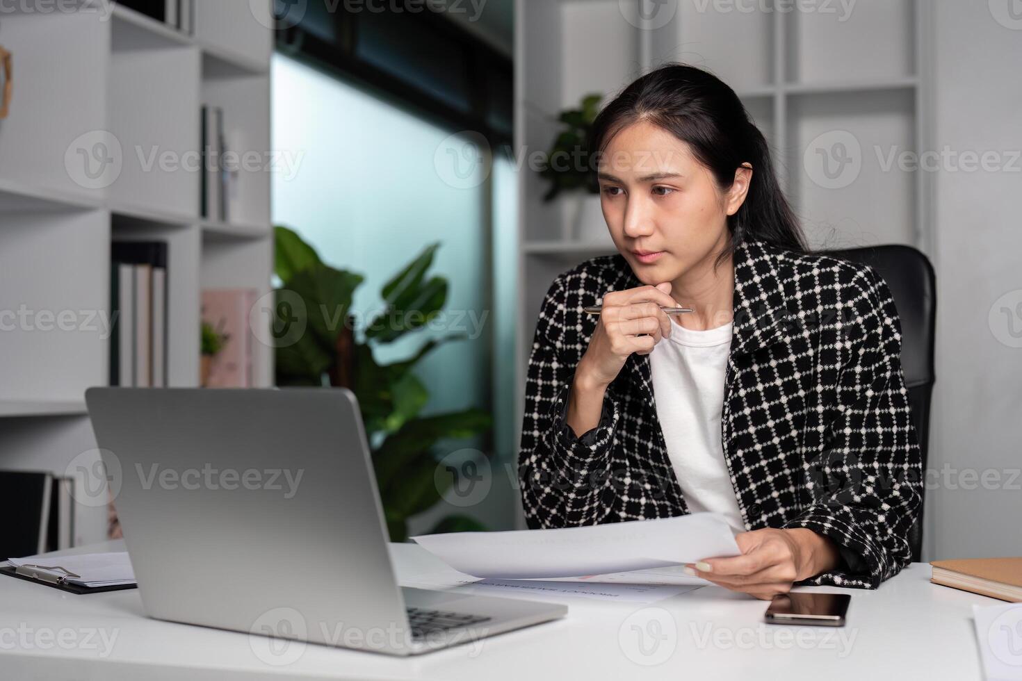 Office Workers Leaving Work Late in a Modern Corporate Environment with Busy Desks and Computers photo