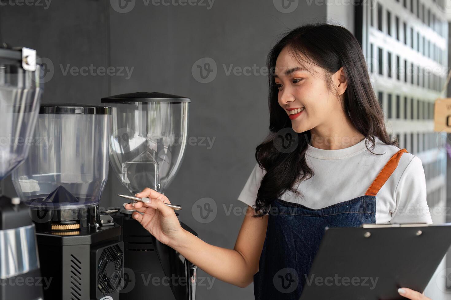 Young Barista Managing a Modern Coffee Shop with a Smile, Operating Coffee Machines and Taking Orders photo
