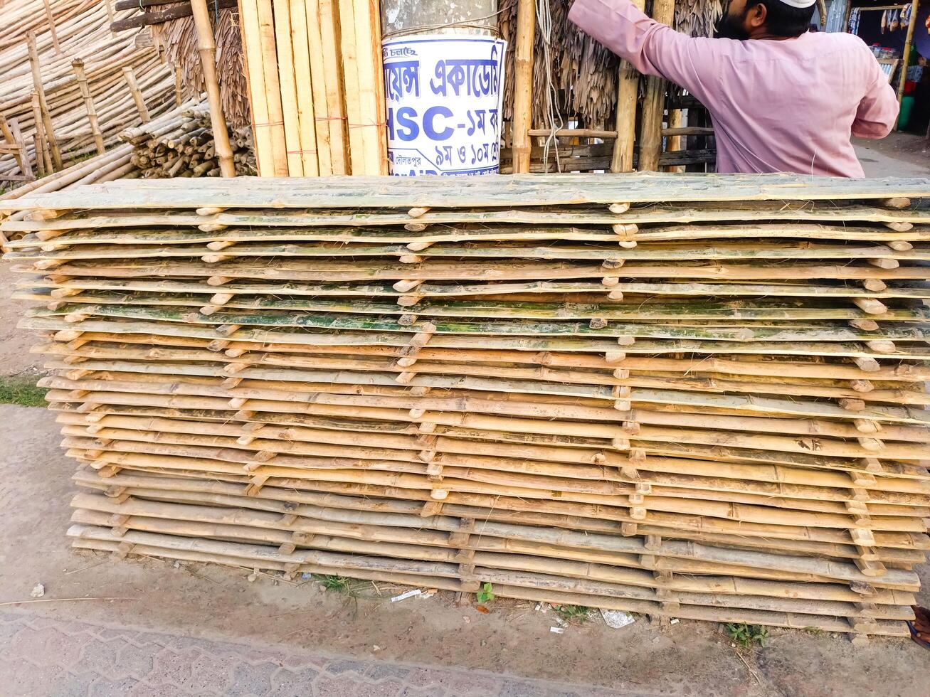 Bundled bamboo matting at a street market green building materials photo