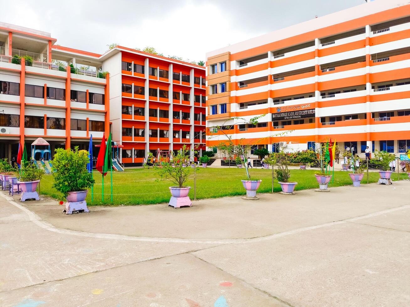 Big Orange and White School Structure with Abundant Parking and Open Yard photo