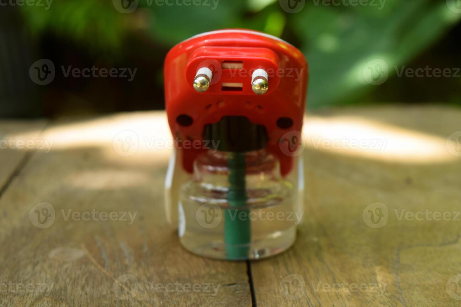 Closeup photo of a red and white electric mosquito fumigator