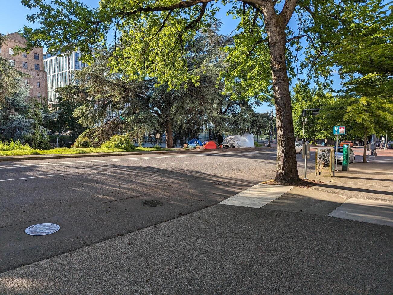 PORTLAND, OREGON, USA - 05.13.2024 A homeless man's tent on a city street photo