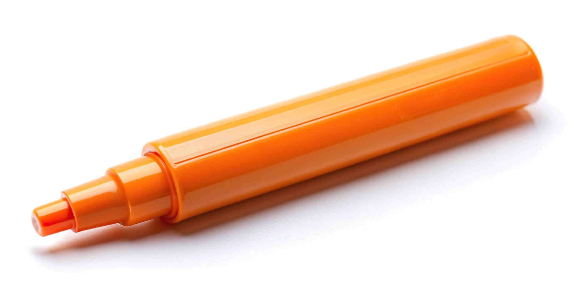A orange marker on a white surface photo