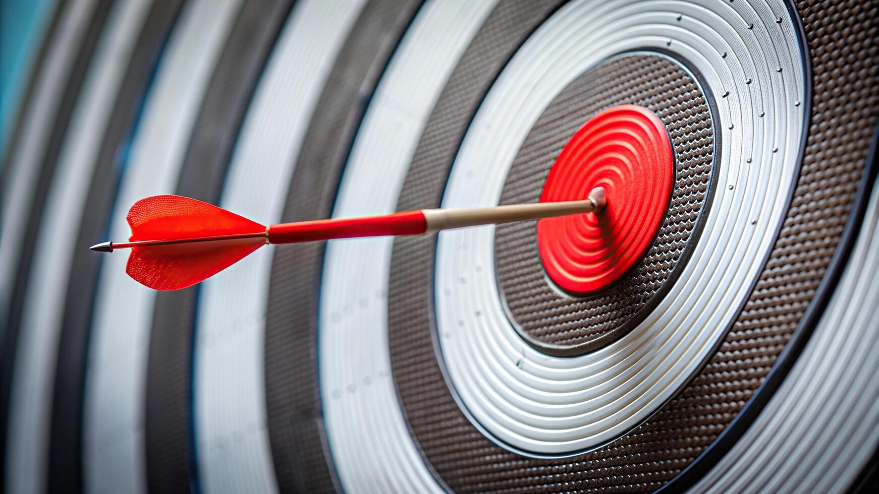 A close up of a target board with a red arrow slightly missing the center creating a forced perspective effect, business., bullseye, strategy, missing the target, determination, close-up photo