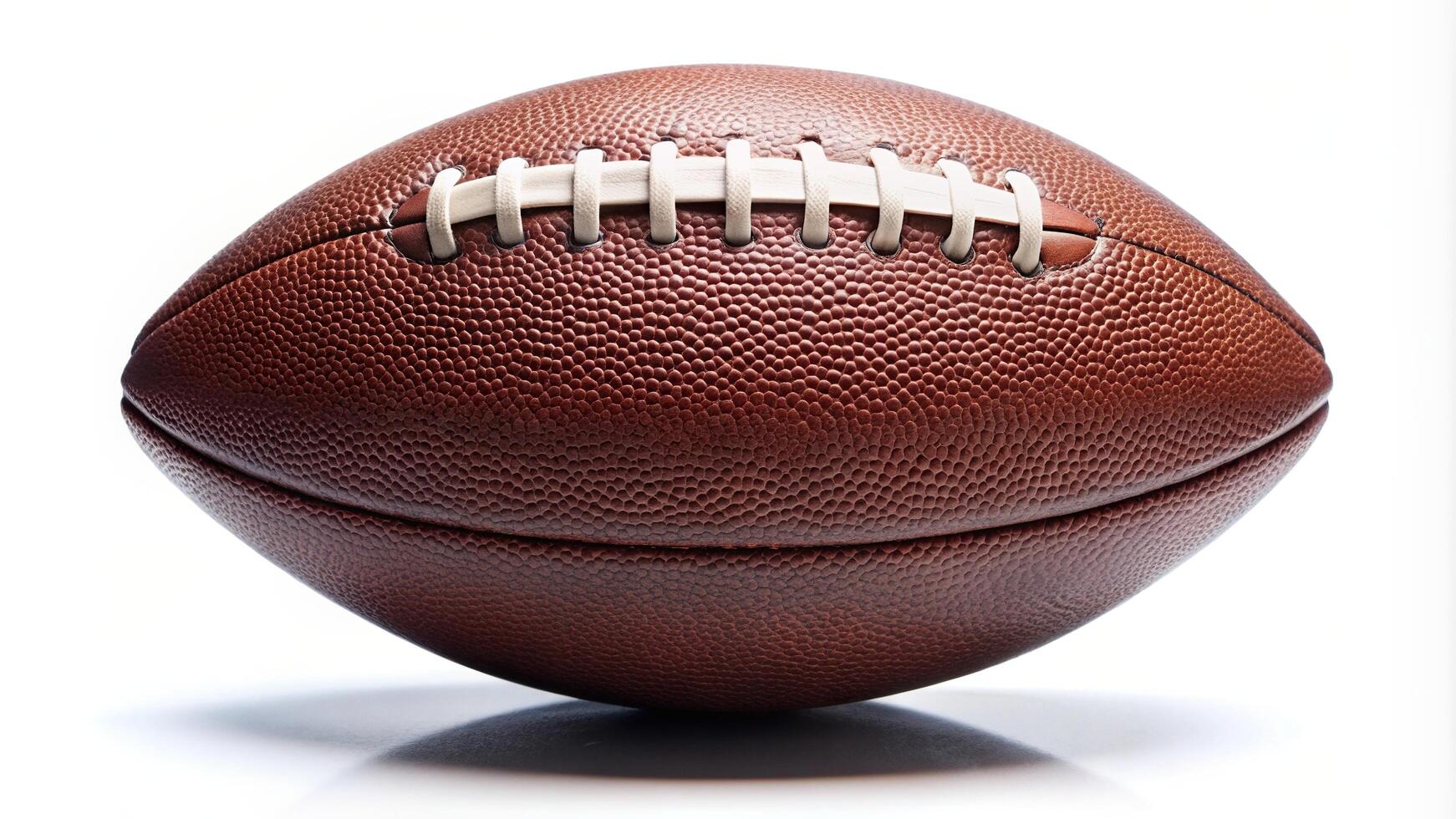 American football ball isolated on a white background showcasing its asymmetrical shape and unique texture, competition, recreation,American football, touchdown, throw photo