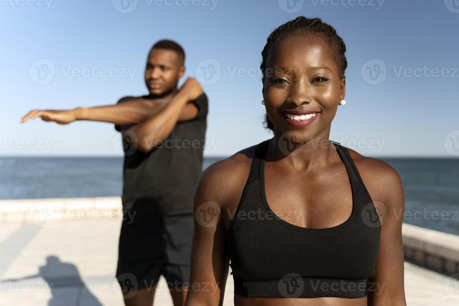 Two multiracial friends training at the summer beach photo