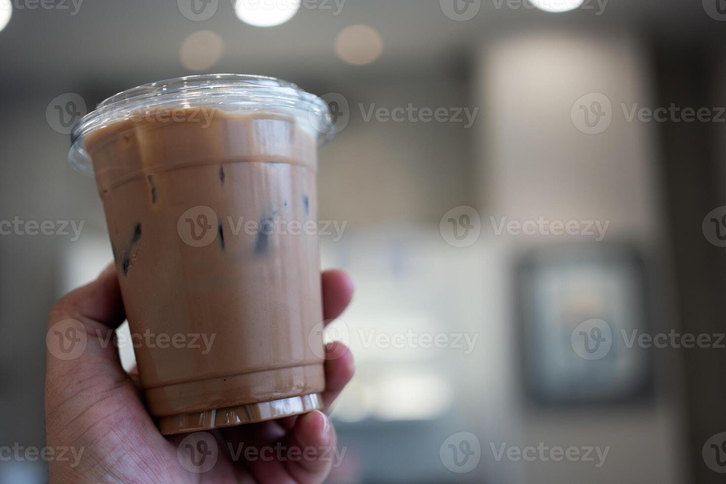 Iced mocha coffee in take away glas on hand photo