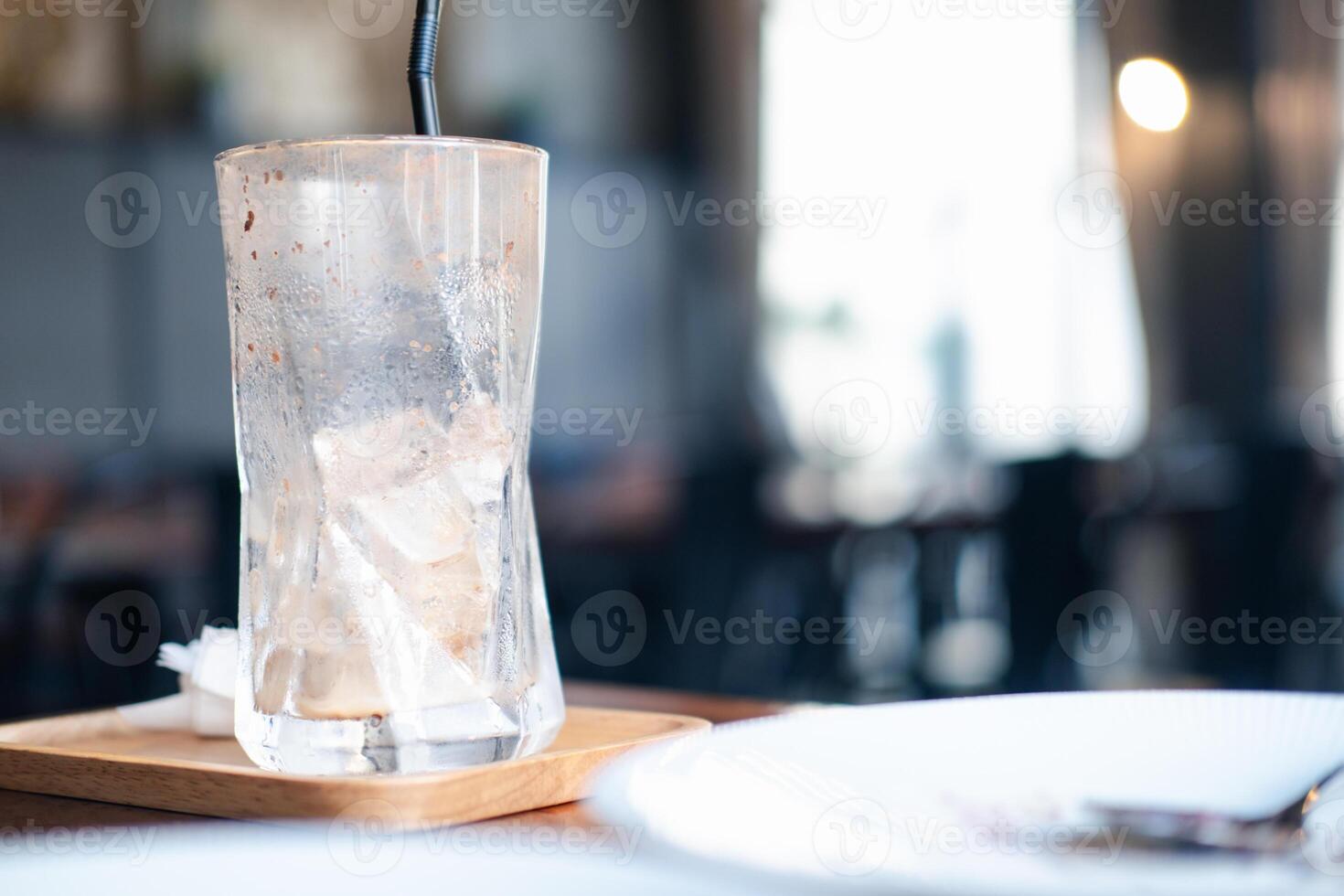 Glass cup of coffee with ice cubes after drinking coffee photo