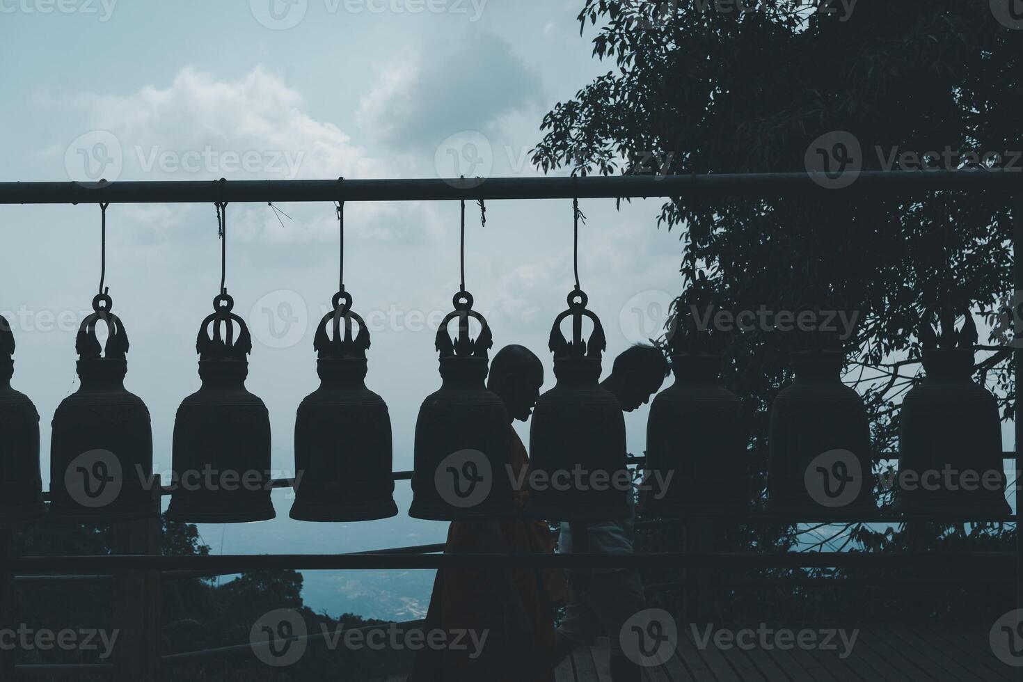 Old bell hangs on steel rail in The stone with the footprint of Lord Buddha at Khitchakut mountain. photo