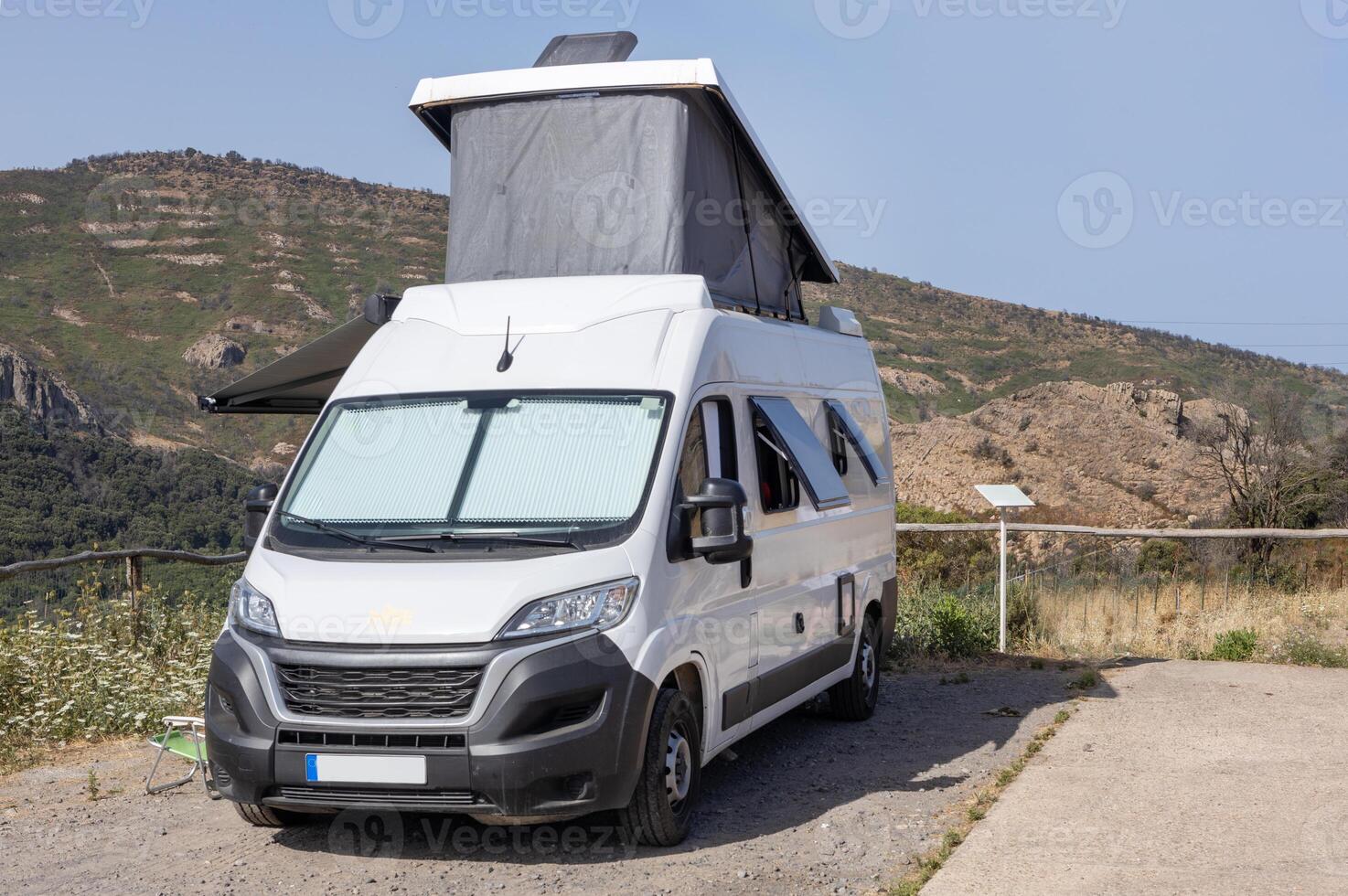Camper Van Parked in Mountain Landscape photo