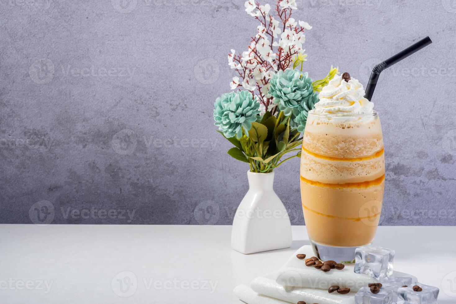 Fresh glass of Coffee Frappe with Whipped Cream and Floral Decor photo
