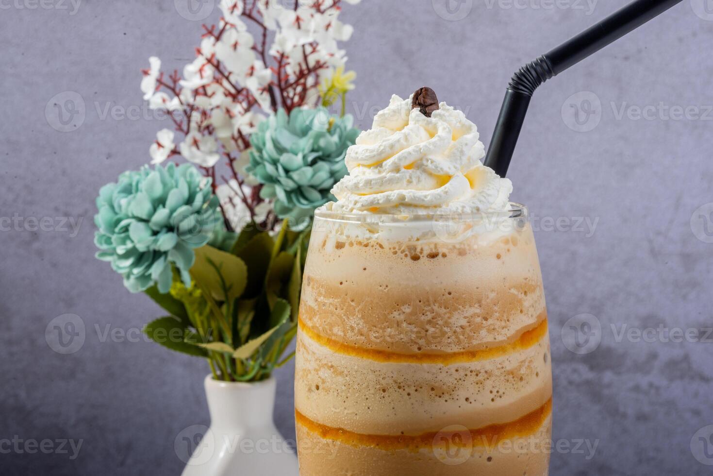 Iced milked Coffee Frappe with Whipped Cream and Floral Decor photo