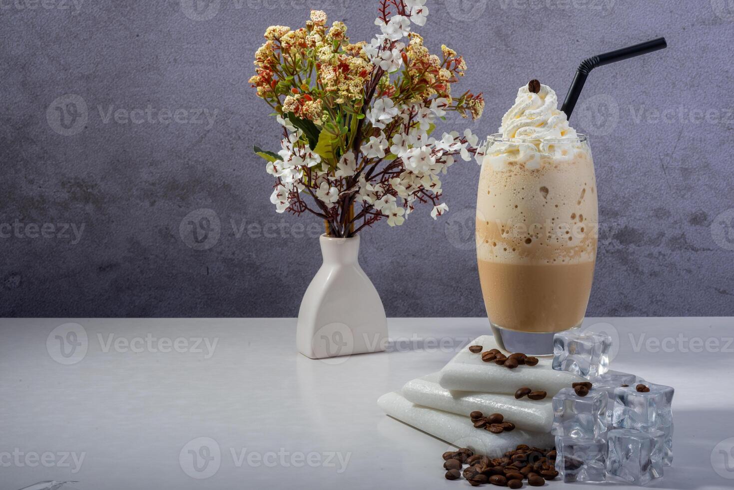 A fresh creamy iced coffee frappe topped with whipped cream photo