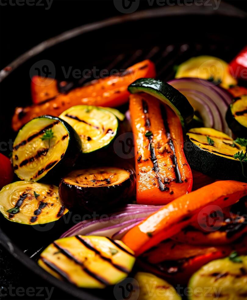 Grilled vegetables on black background with copy space photo