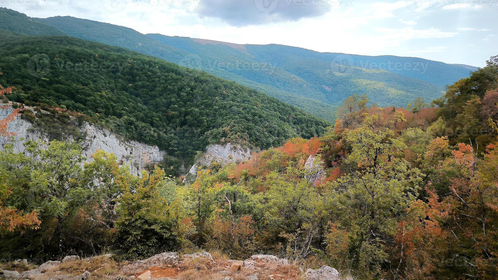 View of the high mountains banner with rocks on the foreground fall autumn. Mountain valley, beige stones, foggy mountains landscape, blue sky, freedom, nature, travel background, journey, meditation photo