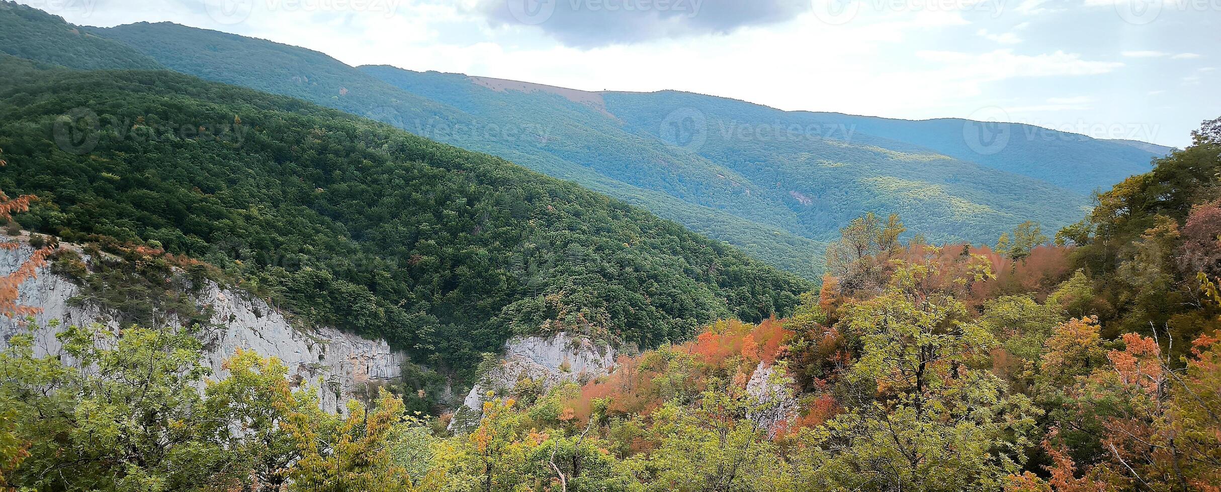 View of the high mountains banner with rocks on the foreground fall autumn. Mountain valley, beige stones, foggy mountains landscape, blue sky, freedom, nature, travel background, journey, meditation photo